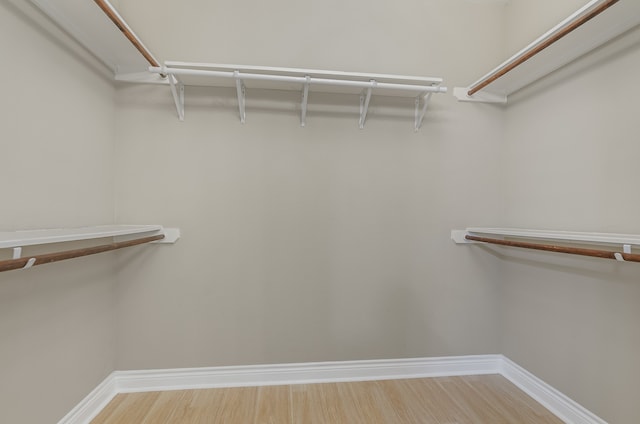 spacious closet featuring hardwood / wood-style floors