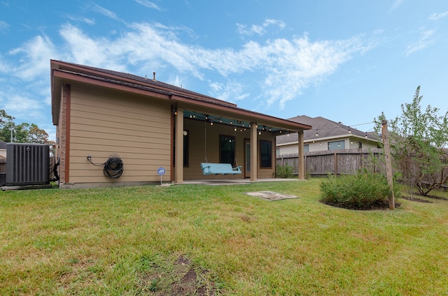 back of property featuring a yard, a patio area, and central AC unit