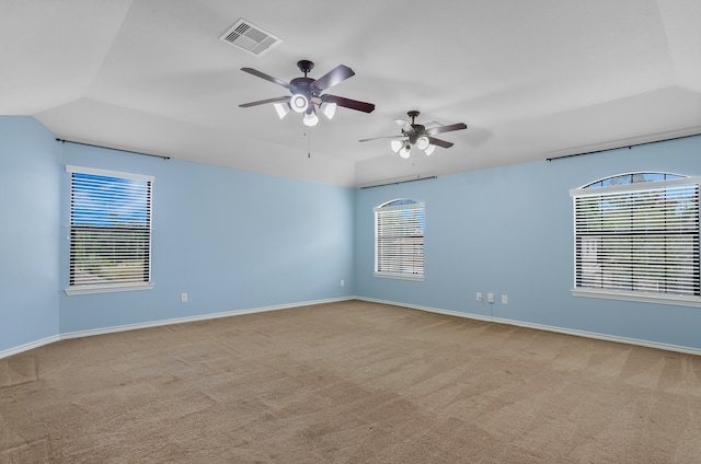 carpeted spare room with ceiling fan and vaulted ceiling