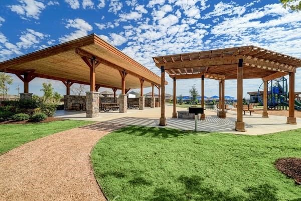 view of community with a pergola, a patio area, and a yard