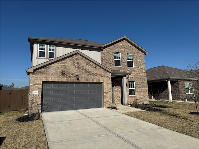 traditional home featuring a garage, fence, concrete driveway, and brick siding