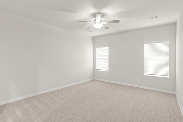 carpeted empty room featuring ceiling fan