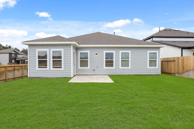 rear view of house with a lawn and a patio