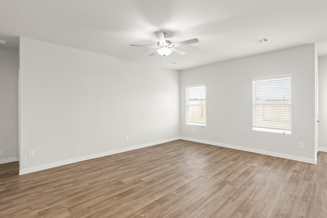 empty room featuring ceiling fan and light hardwood / wood-style floors