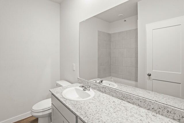 bathroom featuring hardwood / wood-style floors, toilet, and vanity