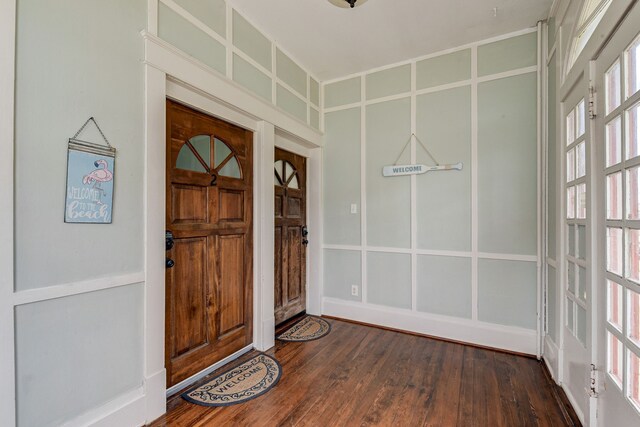 foyer entrance with dark hardwood / wood-style flooring