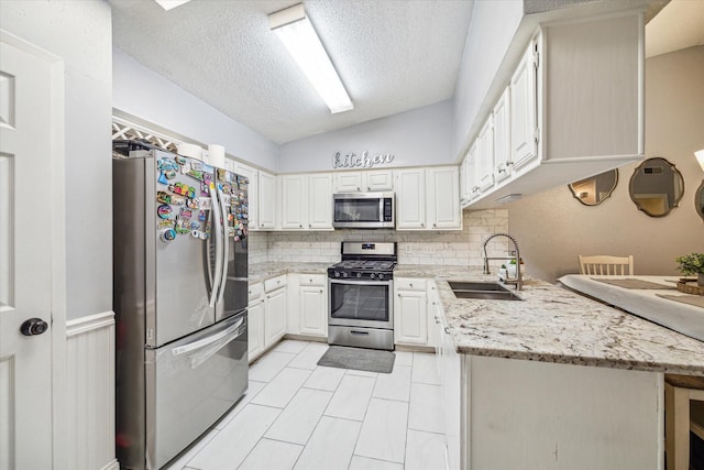 11835 Sandpiper Dr, Houston, TX 77035 - kitchen with stainless steel appliances, a sink, a textured ceiling, backsplash, and white cabinets