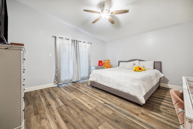 11835 Sandpiper Dr, Houston, TX 77035 - bedroom featuring vaulted ceiling, wood finished floors, a textured ceiling, a ceiling fan, and baseboards