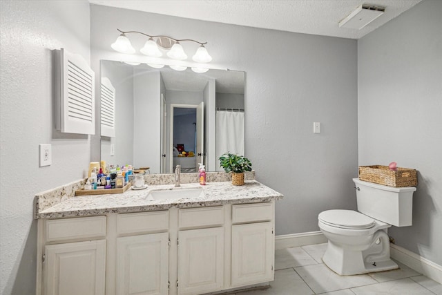 11835 Sandpiper Dr, Houston, TX 77035 - bathroom with toilet, vanity, baseboards, tile patterned flooring, and a textured ceiling