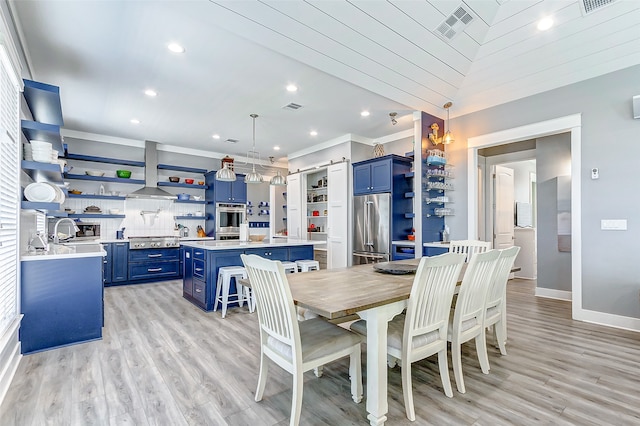 dining area featuring light wood-type flooring and sink