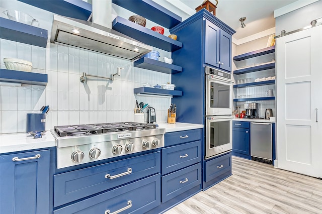 kitchen with backsplash, light wood-type flooring, light stone counters, stainless steel appliances, and blue cabinets