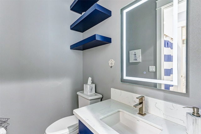 bathroom featuring vanity and toilet