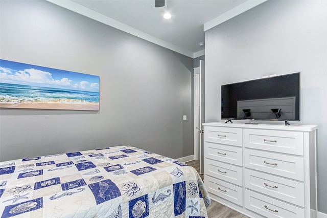 bedroom featuring light hardwood / wood-style flooring and ornamental molding