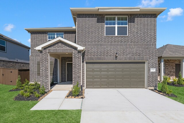 view of front property with a front yard and a garage