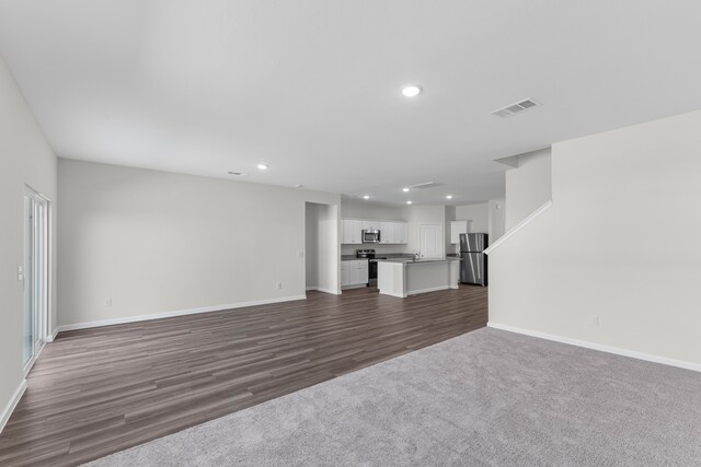 unfurnished living room featuring dark hardwood / wood-style flooring