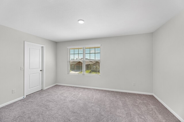 unfurnished room with light colored carpet