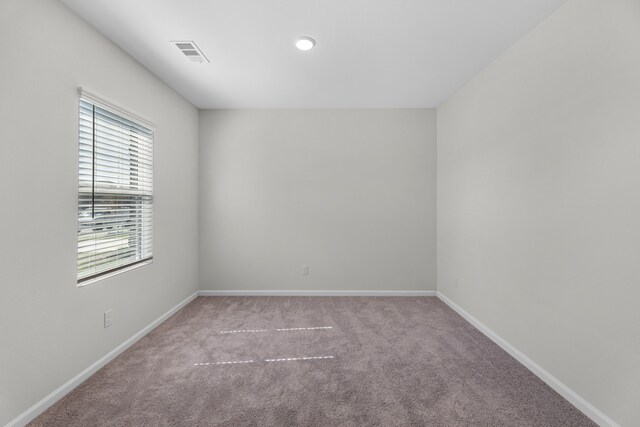 spare room with light colored carpet