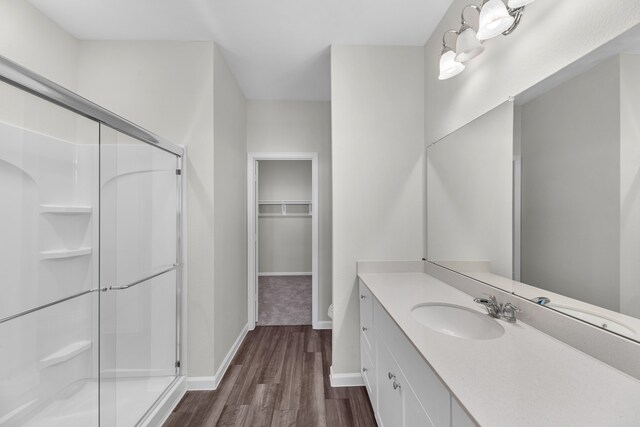 bathroom with vanity, hardwood / wood-style flooring, and an enclosed shower