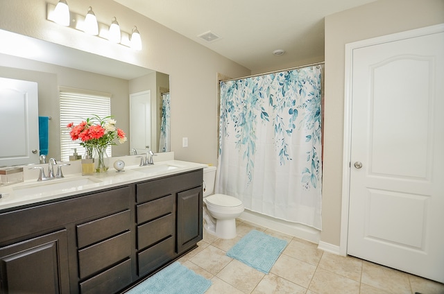 bathroom with tile patterned floors, vanity, and toilet