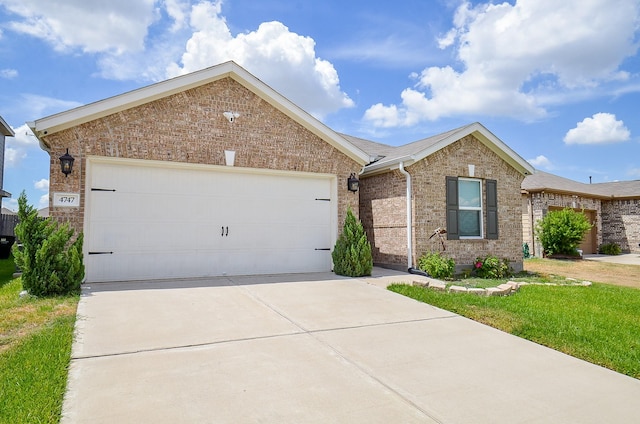 ranch-style house featuring a garage, brick siding, and driveway