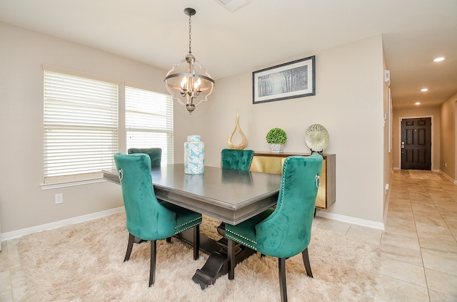 dining space featuring light tile patterned floors and a chandelier