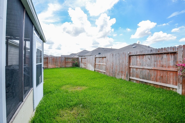 view of yard with a fenced backyard