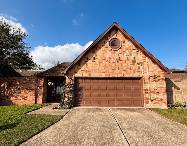 view of front of property with a front lawn and a garage