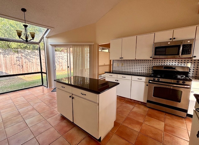 kitchen with stainless steel appliances, decorative light fixtures, lofted ceiling, a center island, and white cabinets