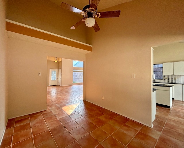 tiled spare room featuring ceiling fan