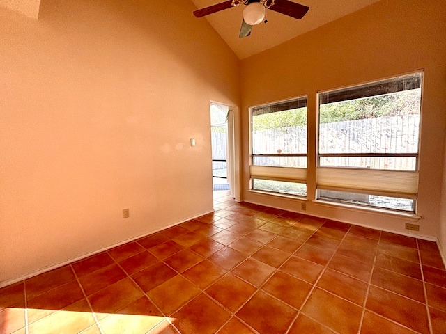 tiled spare room featuring high vaulted ceiling and ceiling fan