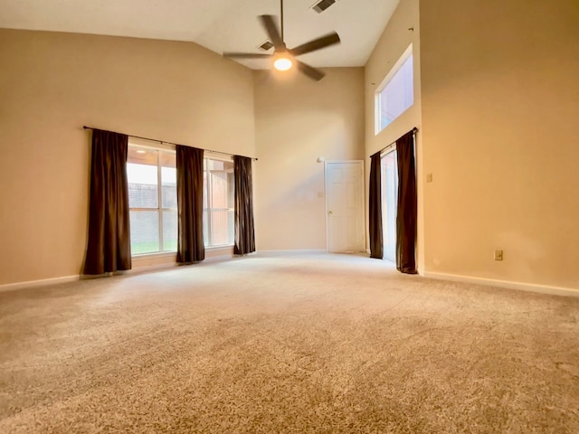 spare room featuring high vaulted ceiling, ceiling fan, and carpet floors