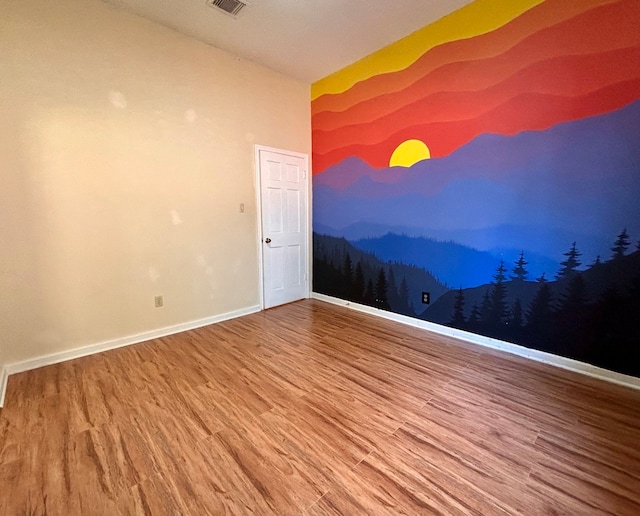 empty room with hardwood / wood-style floors