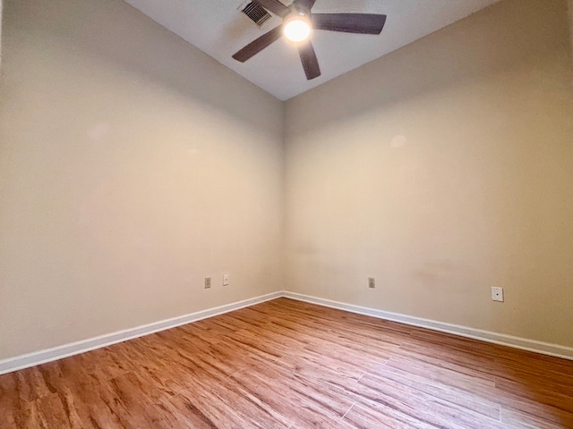 empty room featuring ceiling fan, vaulted ceiling, and light hardwood / wood-style floors