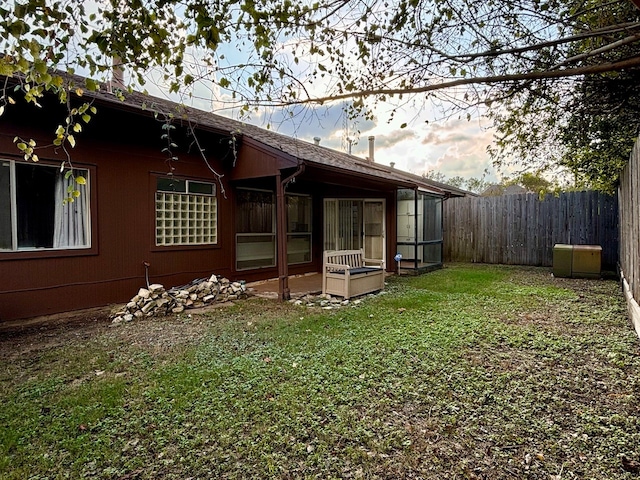 rear view of property featuring a lawn