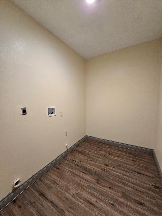 laundry area featuring electric dryer hookup, hookup for a washing machine, dark wood-type flooring, and gas dryer hookup