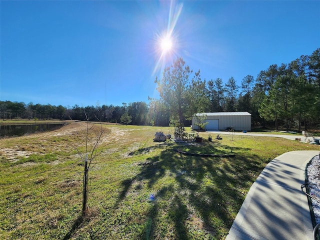 view of yard with an outbuilding, a garage, and a rural view