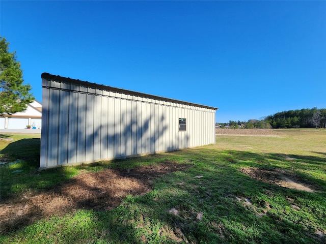 view of outbuilding featuring a yard