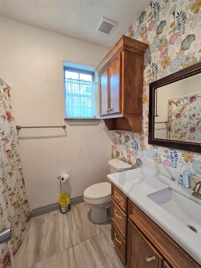 bathroom featuring vanity and toilet