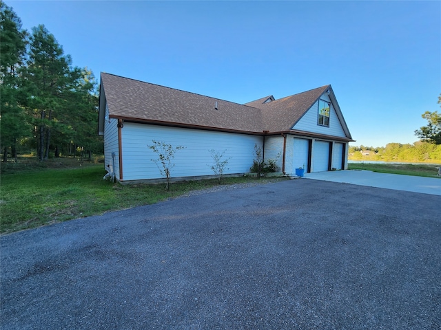 view of front of home with a garage and a front lawn