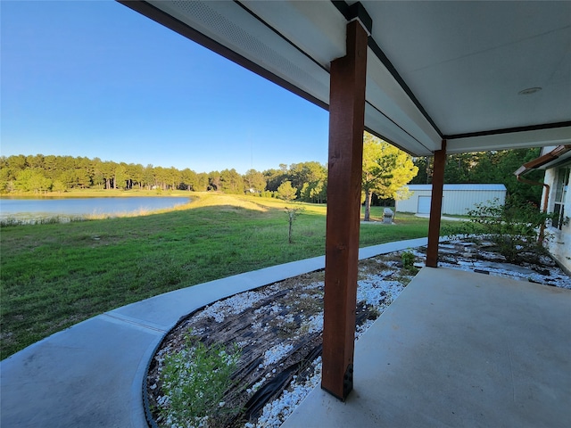 view of yard with a patio area and a water view