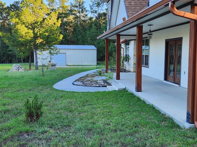 view of yard featuring a garage and an outdoor structure