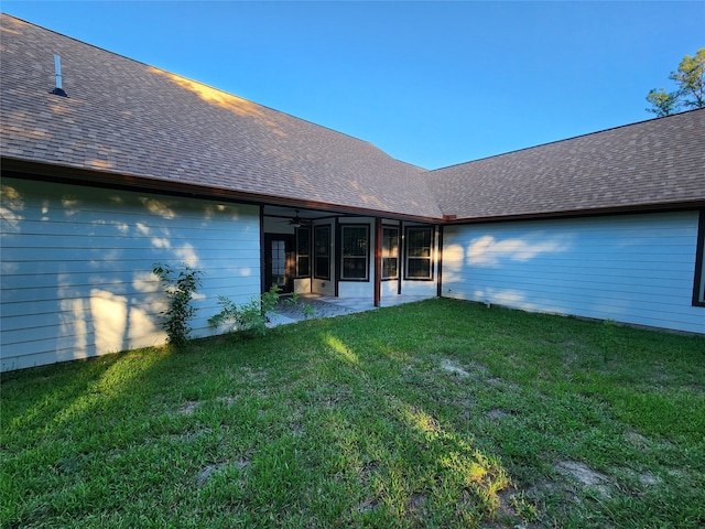 back of house featuring a yard and a patio area