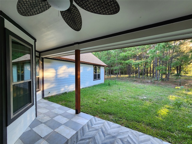 view of yard with ceiling fan and a patio area