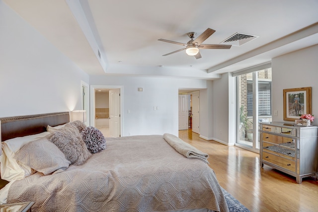 bedroom with light wood-type flooring, ceiling fan, access to outside, and connected bathroom