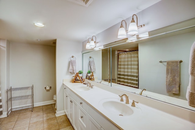 bathroom featuring a shower with curtain, vanity, toilet, and tile patterned floors