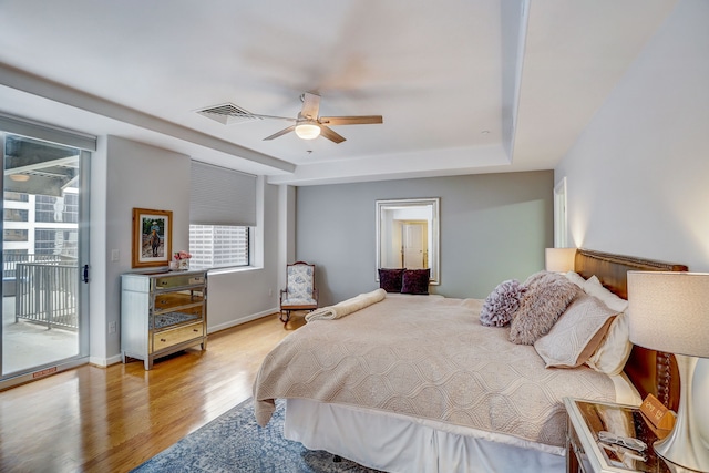 bedroom featuring ceiling fan, light hardwood / wood-style floors, and access to outside