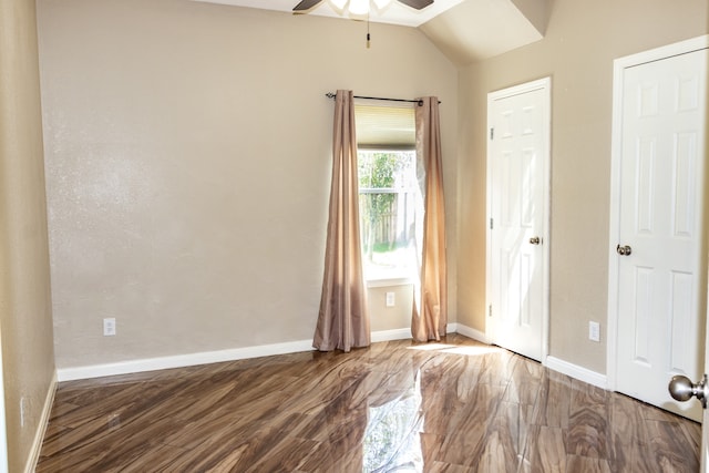 interior space featuring ceiling fan, dark hardwood / wood-style floors, and lofted ceiling