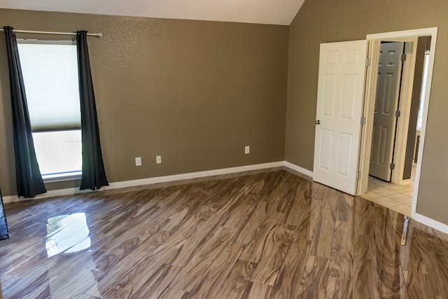 interior space with light hardwood / wood-style flooring and lofted ceiling