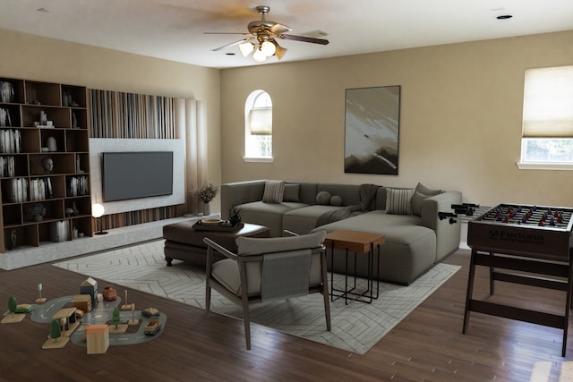 living area with a ceiling fan and wood finished floors