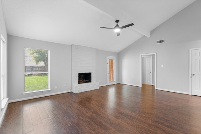 unfurnished living room featuring beamed ceiling, high vaulted ceiling, a brick fireplace, dark hardwood / wood-style flooring, and ceiling fan